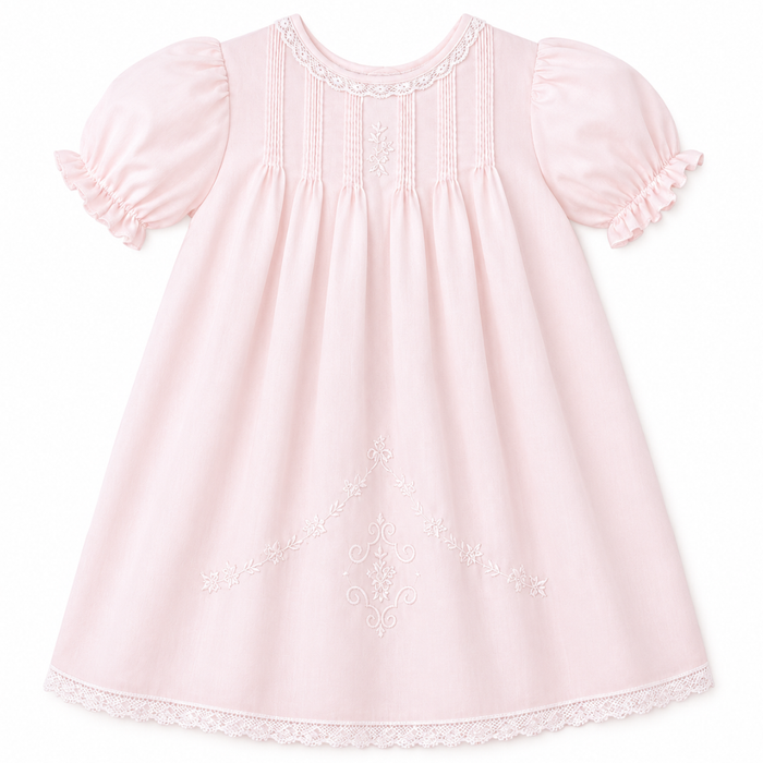 Pink baby dress with pintuck pleats, puff sleeves, lace trim, embroidery details, and matching slip underneath.