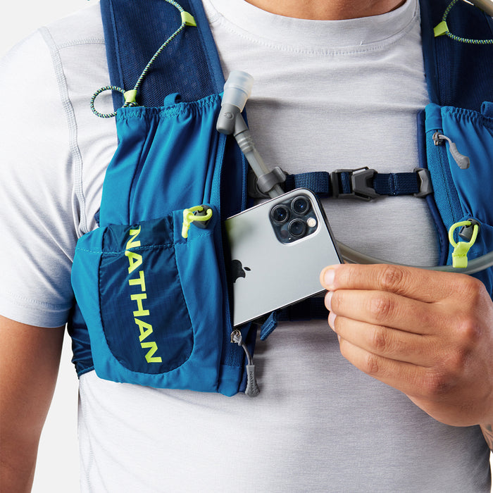 color:Deep Blue/Safety Yellow||seo:Nathan VaporAir 3.0 7 Liter Men's Hydration Pack - Deep Blue/Safety Yellow - On Model - Pulling Cell Phone From Pocket