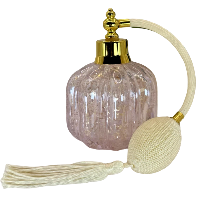 Decorative lamp with textured glass shade, gold accents, and tassel on a white background