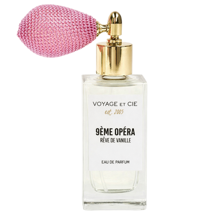 Perfume bottle with pink cap and gold accents on a white background