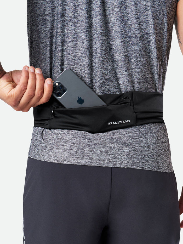 color:Black||seo:Nathan Adjustable-Fit Zipster 2.0 Black Training Waist Belt - Model Pulling Out iPhone From Pocket