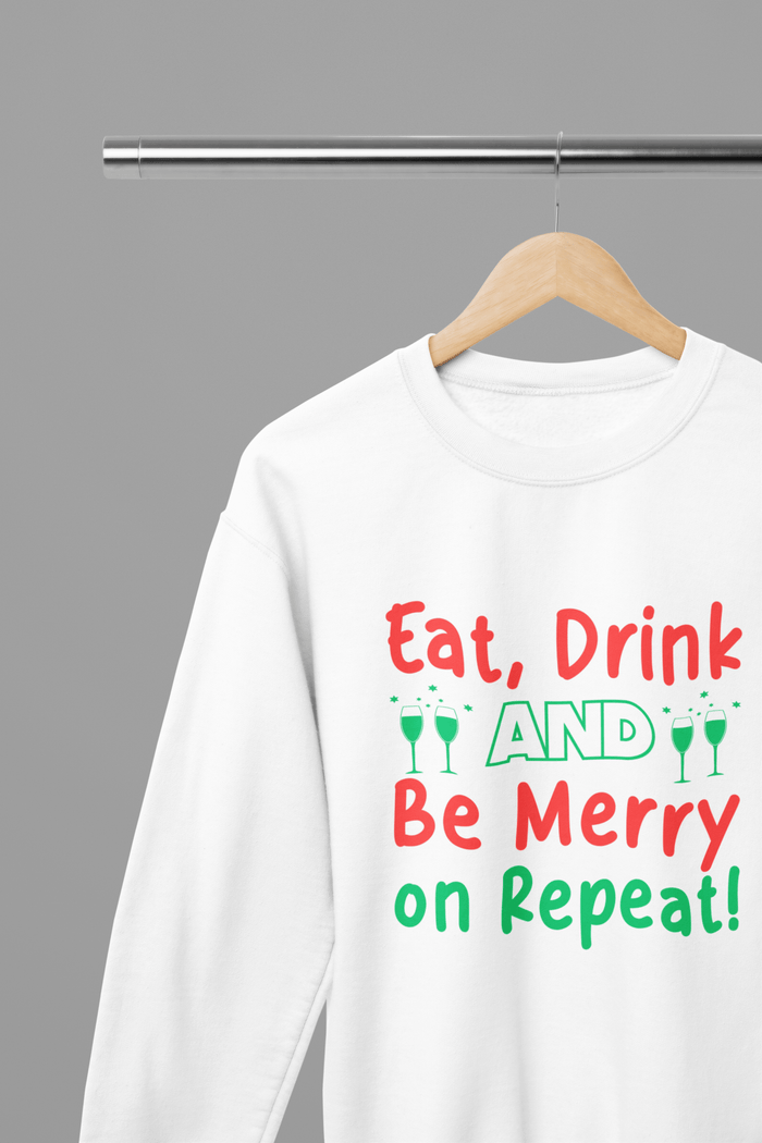 white sweatshirt with eat drink be merry repeat christmas slogan