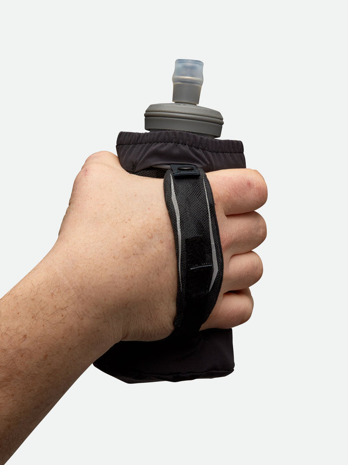 color:Black/Sailor Blue||seo:Nathan ExoDraw 2.0 18oz Hydration Handheld - Black/Sailor Blue - Model Holding Handheld with Strap - Back View