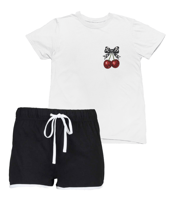 white kids t-shirt with cherry and checkered bow design paired with black shorts