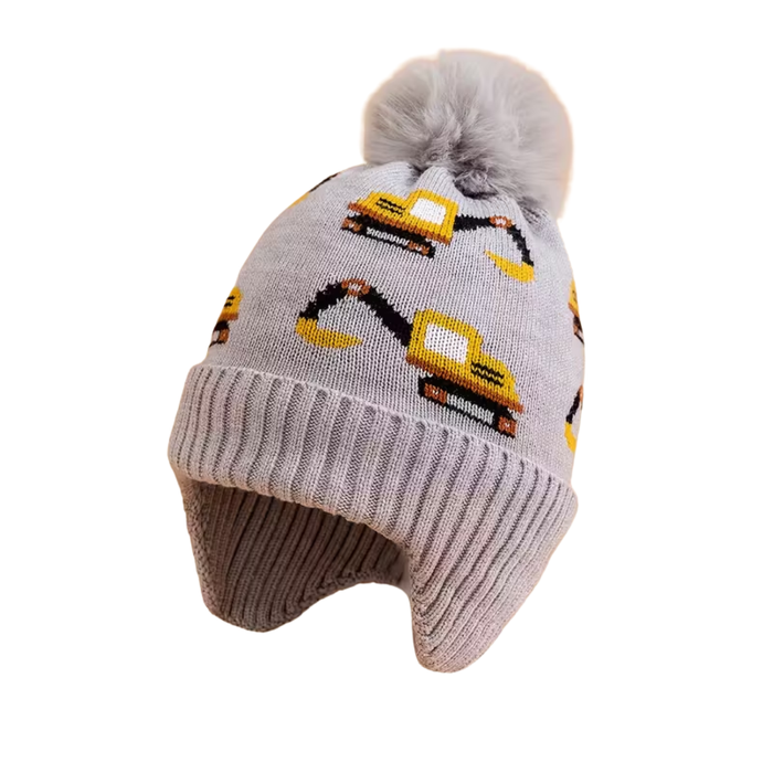 Grey kids’ knit beanie with a fluffy pom-pom and yellow excavator designs, featuring earflaps for added warmth.