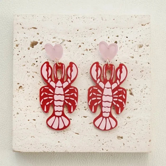 glossy red lobster heart earrings side view showing soft pink heart details
