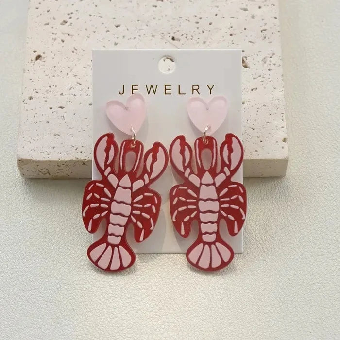 fun quirky lobster earrings with dangling heart design statement jewellery