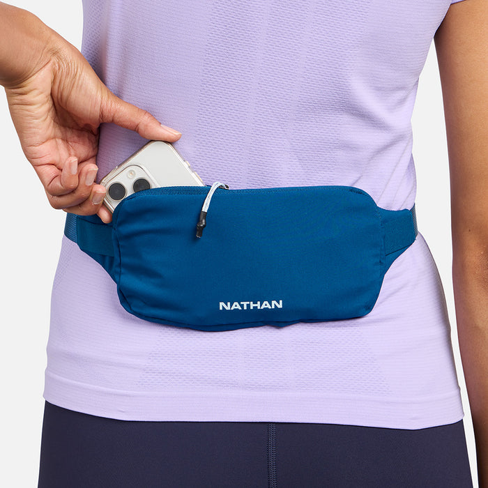 color:Sailor Blue/Light Blue||seo:Nathan Marathon Waist Pack 3.0 - Sailor Blue/Light Blue - On Model - Pulling iPhone From Storage Pocket