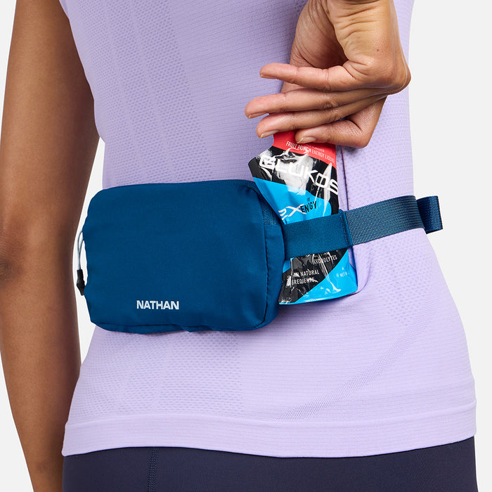 color:Sailor Blue/Light Blue||seo:Nathan Marathon Waist Pack 3.0 - Sailor Blue/Light Blue - On Model - Pulling Glukos Energy Gel (Fruit Punch Flavor) From Keeper