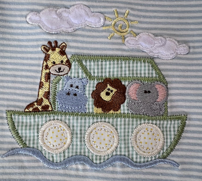 close up of noah's ark applique with giraffe, hippo, lion, elephant
