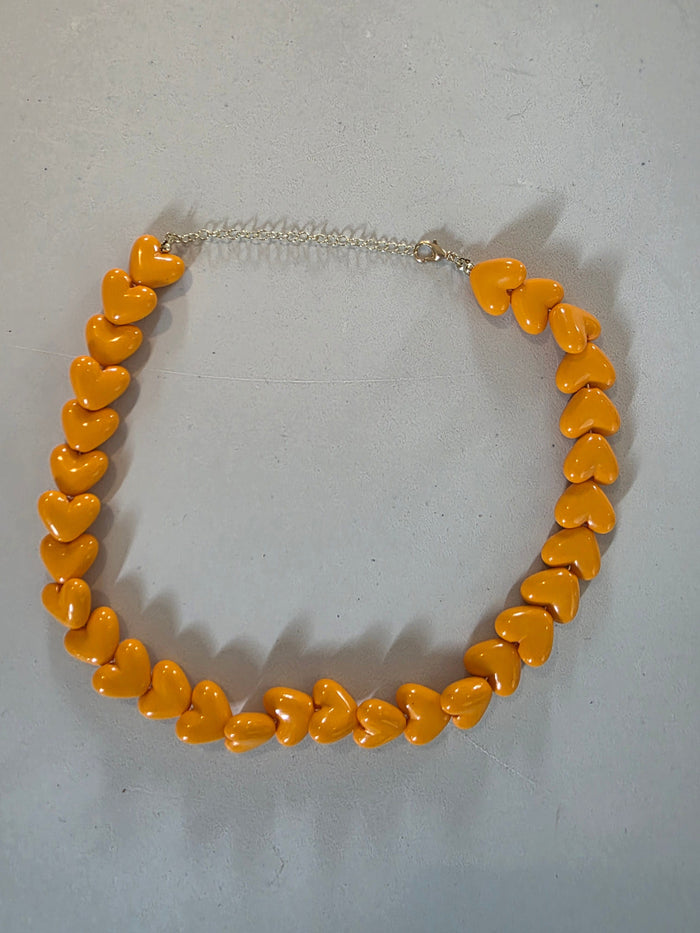 bold orange heart statement necklace front view showing design detail
