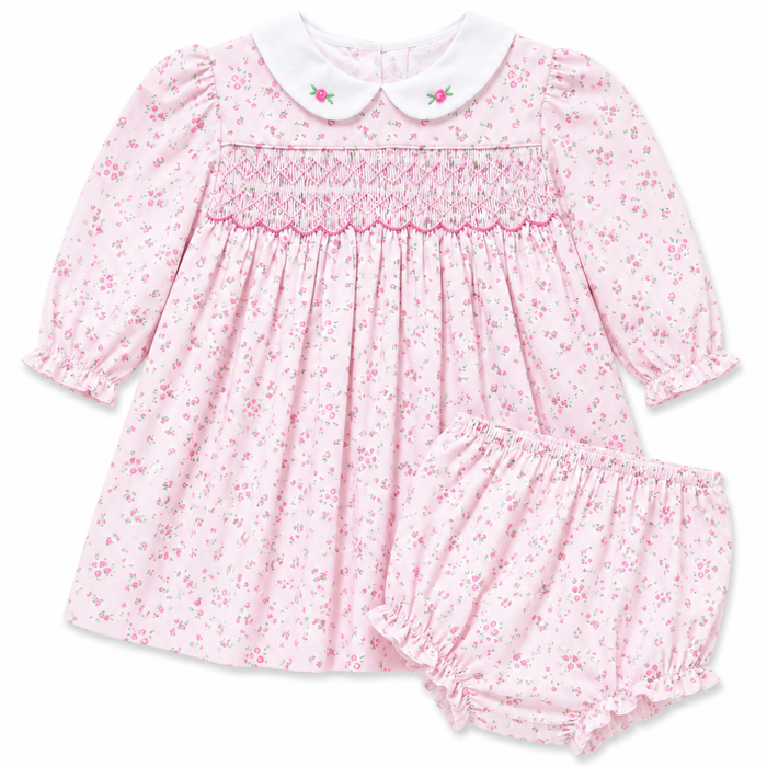 Girls pink floral smocked dress with Peter Pan collar and long sleeves. Classic heirloom-inspired style for special occasions.