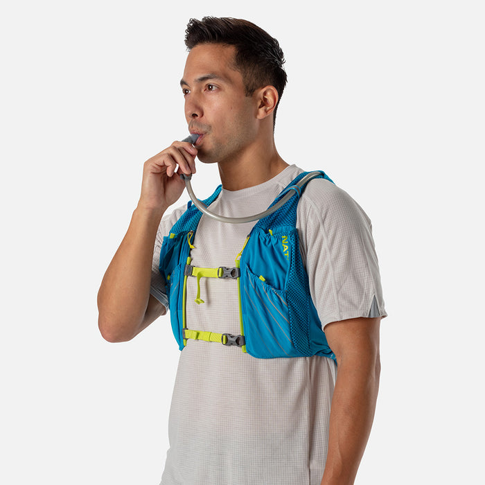 color:Blue Me Away/Finish Lime||seo:Nathan Pinnacle 12 Liter Unisex Hydration Race Vest - Blue Me Away/Finish Lime Green - Male Runner Taking Sip of Water From Bladder Hose Bite Valve