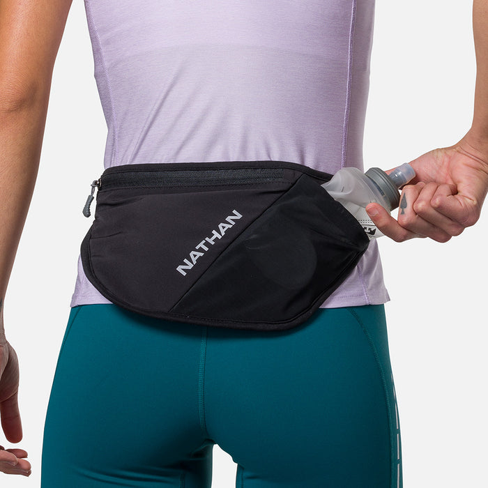 color:Black/Reflective Silver||view:sku image back||seo:Nathan Pinnacle FeatherLite Unisex Hydration Waist Belt -Black/Reflective Silver - Model Pulling 18oz Flask from Pouch