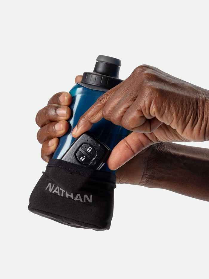 color:Black/Marine Blue||seo:NATHAN QuickSqueeze Lite 12oz Hydration Handheld - Black/Marine Blue - Runner Pulling Out Key Fob From Pocket of Handheld