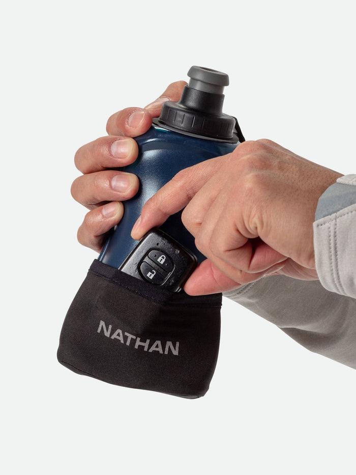 color:Black/Marine Blue||seo:NATHAN QuickSqueeze Lite 18oz Handheld - Black/Marine Blue - Runner Pulling Out Key Fob From Pocket of Handheld