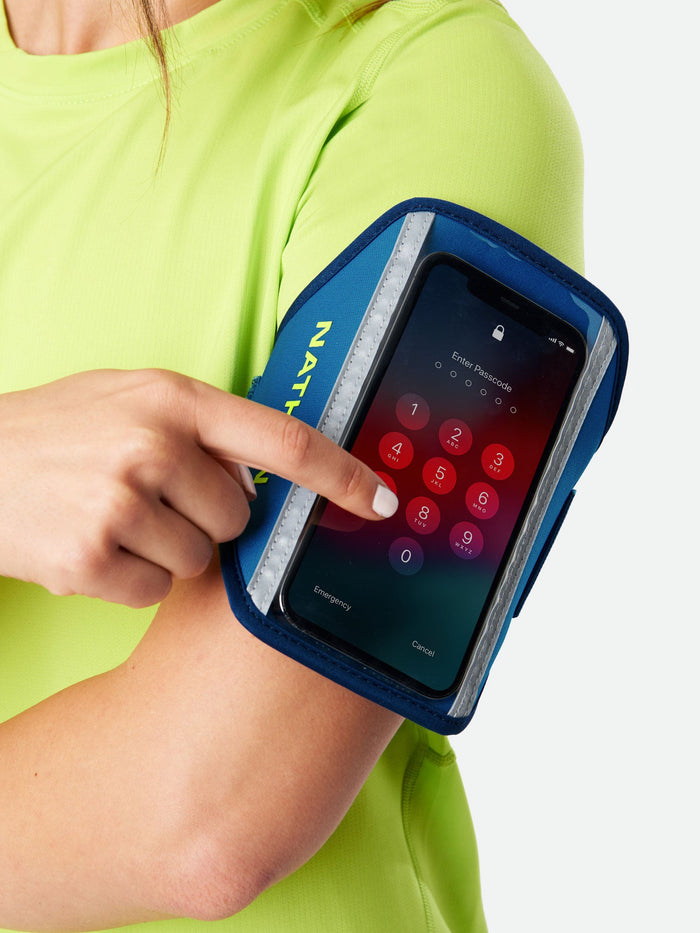 color:Deep Blue/Safety Yellow||seo:Nathan Super 5K Smartphone Armband - Deep Blue/Safety Yellow - On Model - Armband Detail View with Cellphone - Unlocking Phone