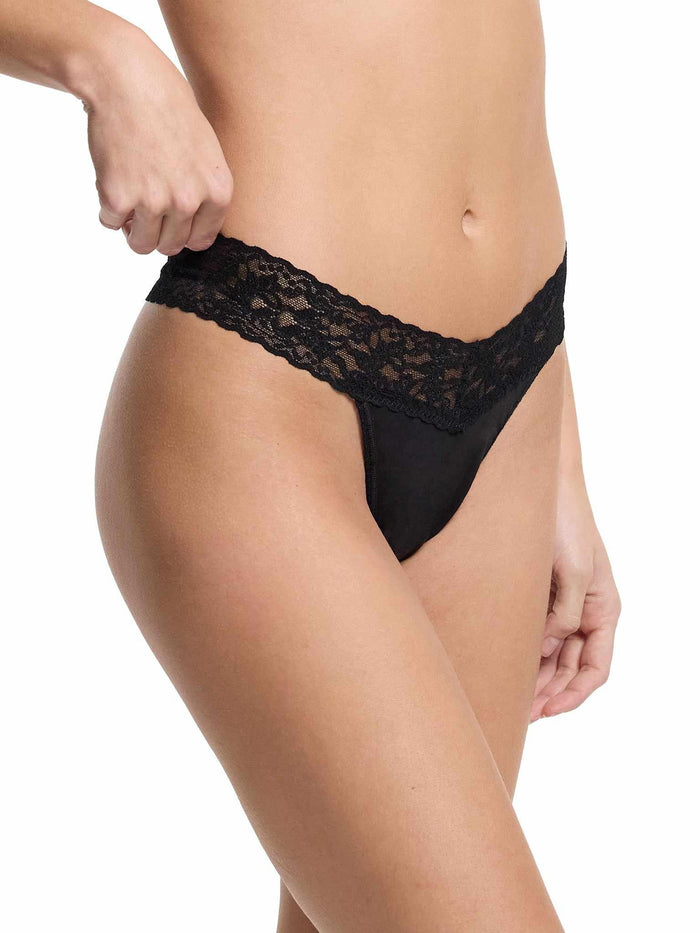 Black cotton thong with stretch lace waistband, model pulling side - Side View | Hanky Panky