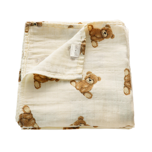 Cream bamboo muslin baby swaddle blanket with an allover vintage teddy bear print.