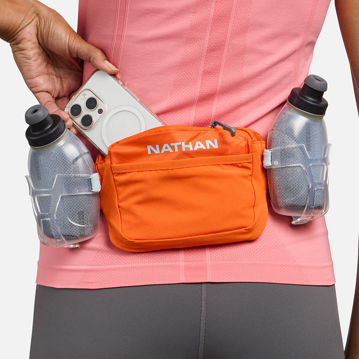 color:Orange Blaze/Reflective Silver||seo:Nathan TrailMix Plus Insulated Hydration Waist Belt 3.0 - Orange Blaze/Reflective Silver - On Model - Pulling Cell Phone From Pocket