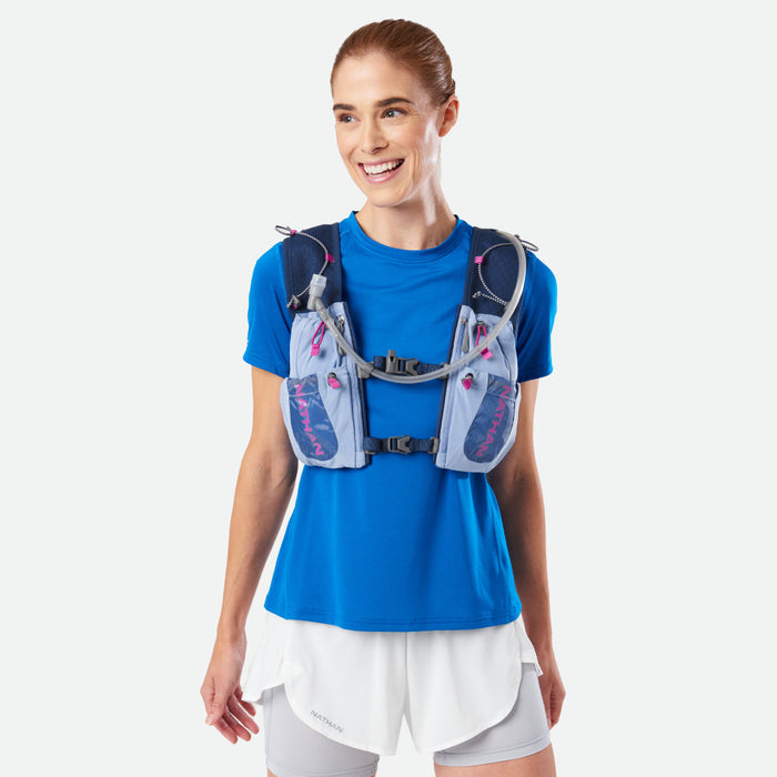 color:Periwinkle/Magenta||seo:Nathan VaporAiress 3.0 7 Liter Women's Hydration Pack - Periwinkle/Magenta - On Model - Front View