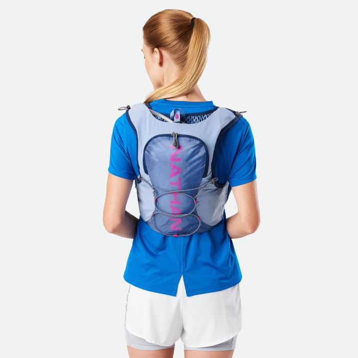 color:Periwinkle/Magenta||seo:Nathan VaporAiress 3.0 7 Liter Women's Hydration Pack - Periwinkle/Magenta - On Model - Back View