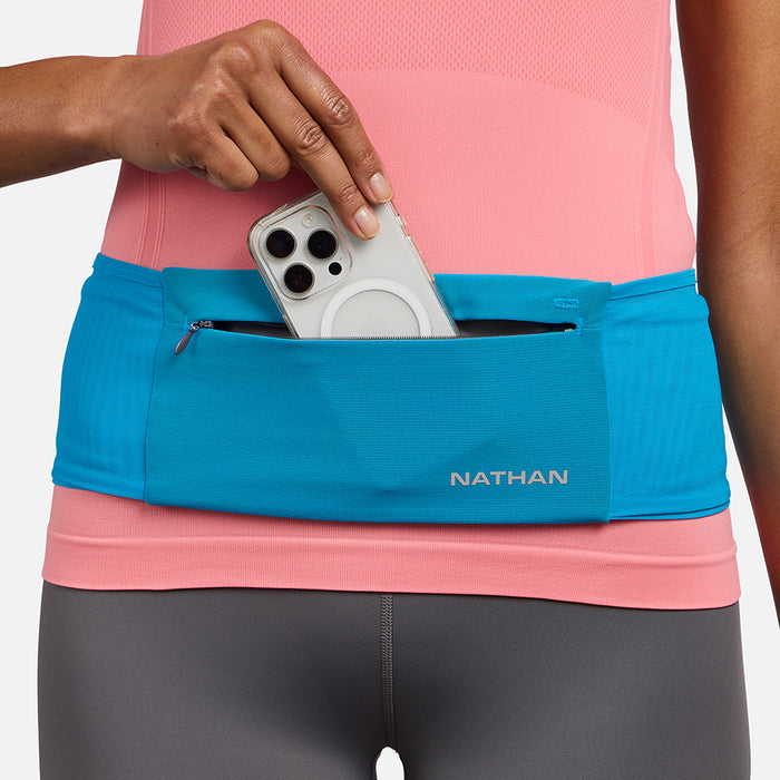 color:Electric Blue/Reflective Silver||seo: Nathan Zipster Max Training Waist Belt - Electric Blue/Reflective Silver - Model Pulling Out iPhone From Storage Pocket