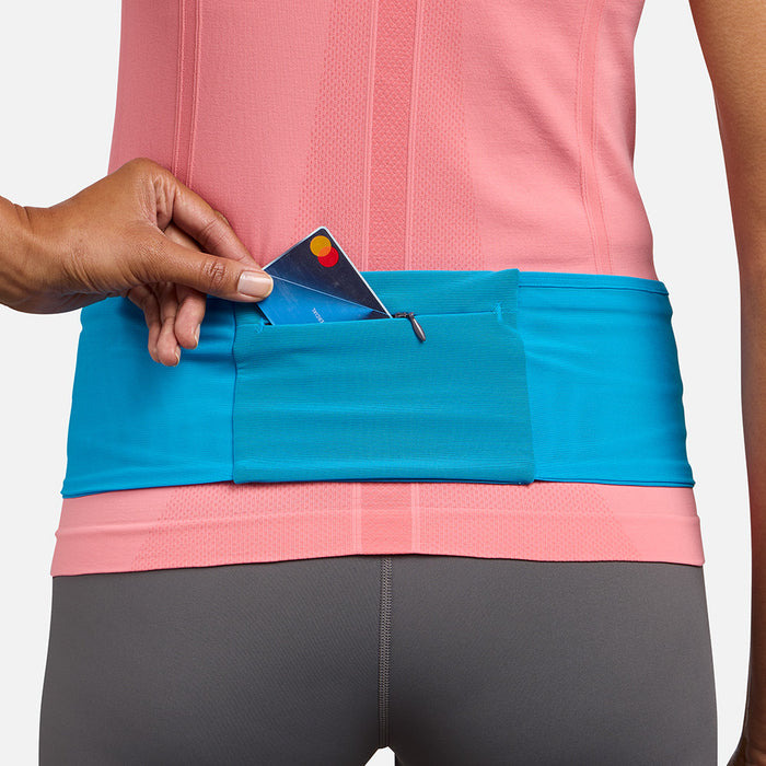 color:Electric Blue/Reflective Silver||seo: Nathan Zipster Max Training Waist Belt - Electric Blue/Reflective Silver - Model Pulling Credit Card out of Zippered Pocket