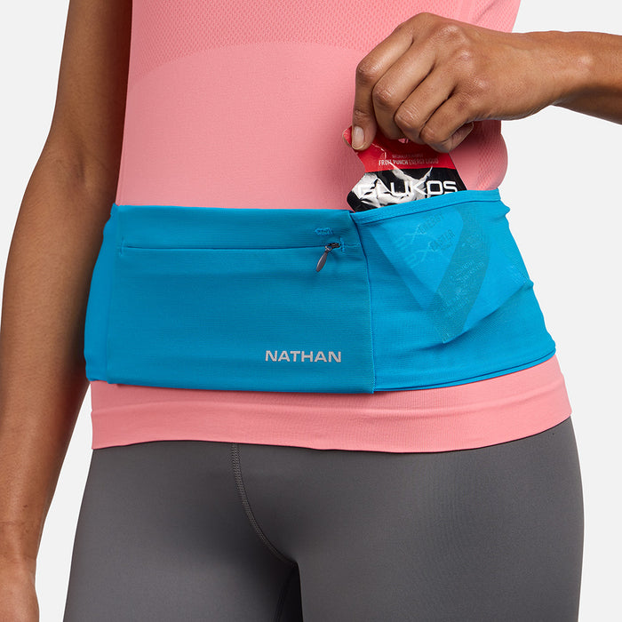 color:Electric Blue/Reflective Silver||seo: Nathan Zipster Max Training Waist Belt - Electric Blue/Reflective Silver - Model Pulling Glukos Energy Gel (Fruit Punch Flavor) Out of Side Storage Pocket